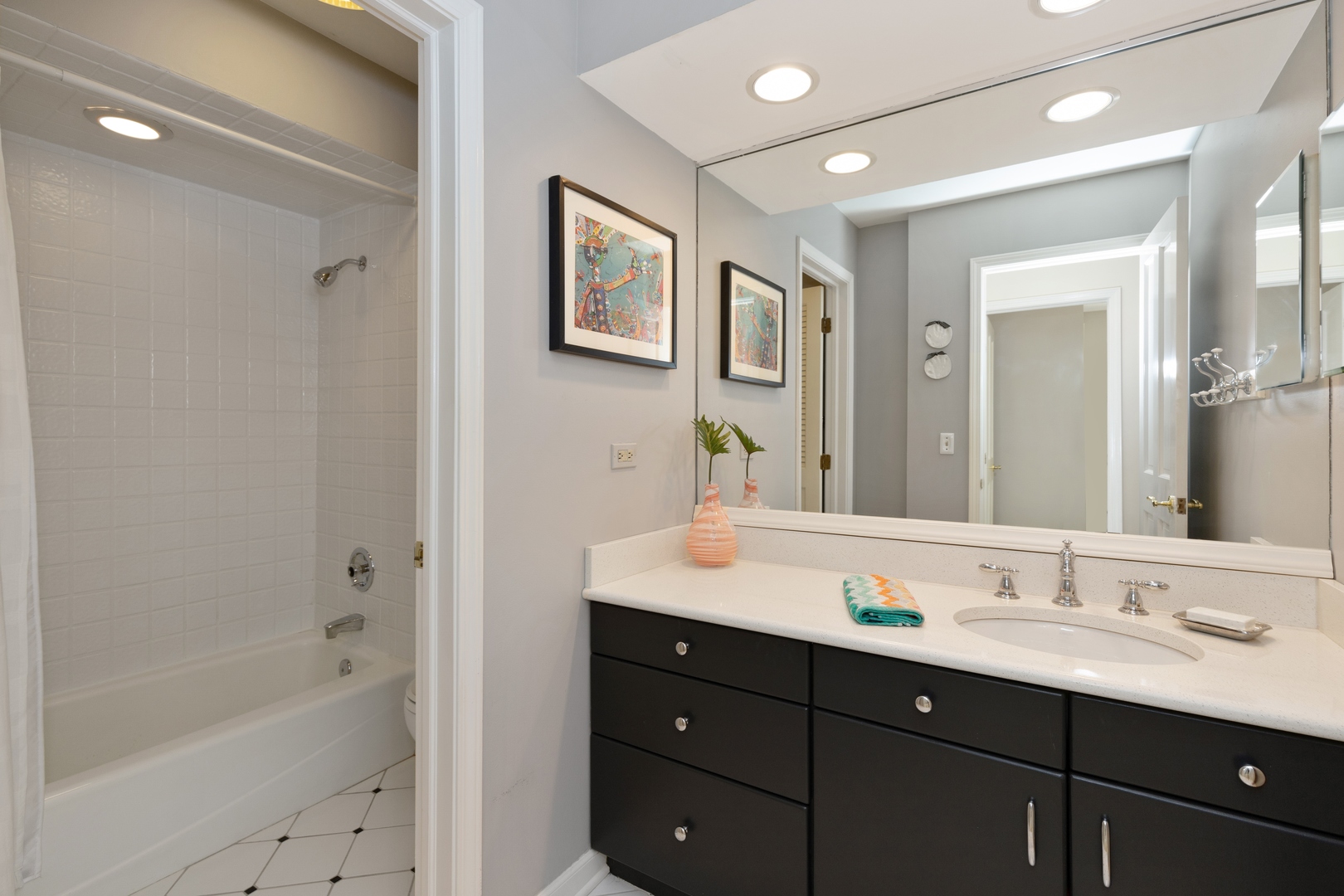 390 South Basswood Road Lake Forest, IL 60045 - Photo 21 of 38 a bathroom with a tub a sink double vanity and mirror