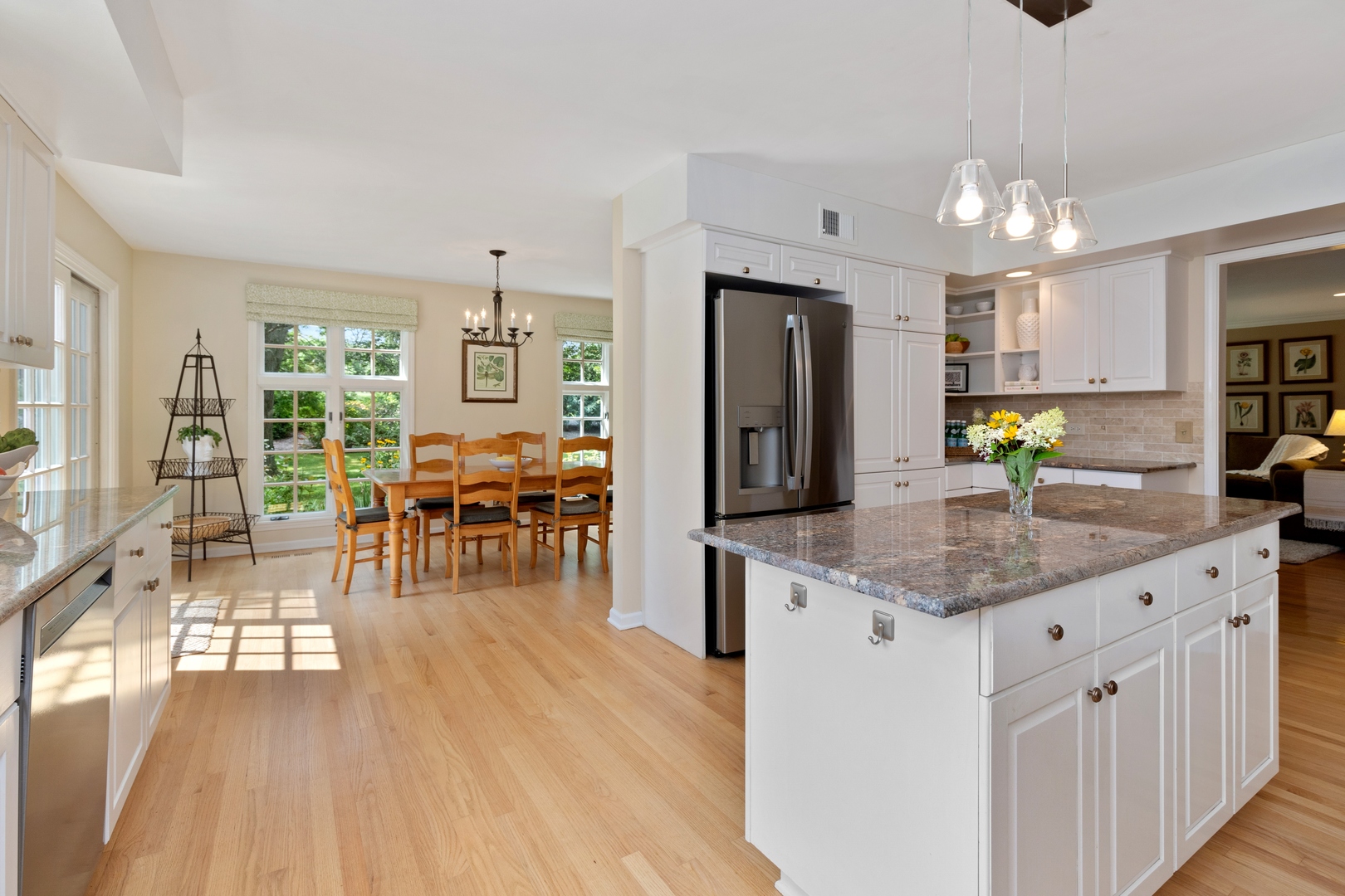 390 South Basswood Road Lake Forest, IL 60045 - Photo 10 of 38 a kitchen with stainless steel appliances granite countertop a refrigerator a sink dishwasher a dining table and chairs with wooden floor