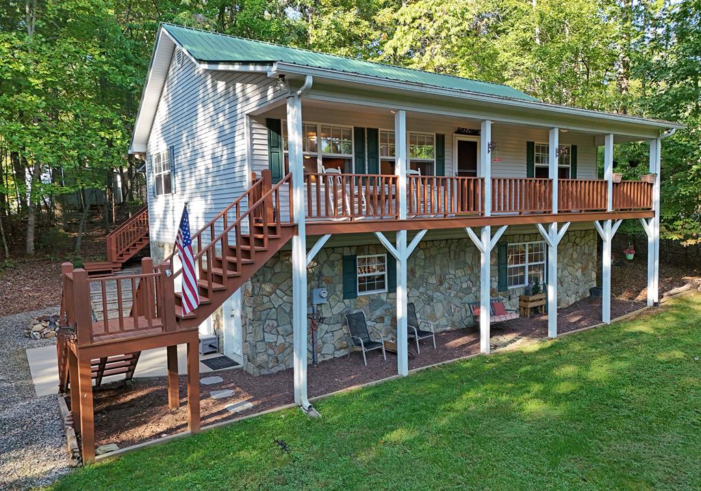 a front view of a house with garden and deck