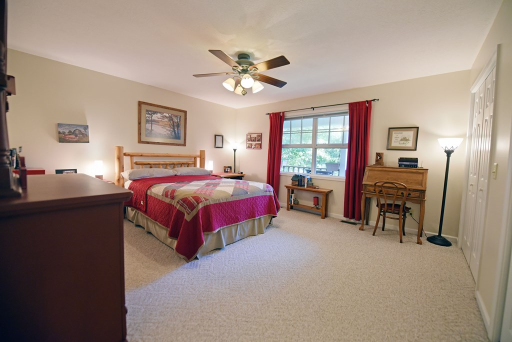 31 Lance Crossing Road Blairsville, GA 30512 - Photo 41 of 52 a bedroom with a bed and a chandelier