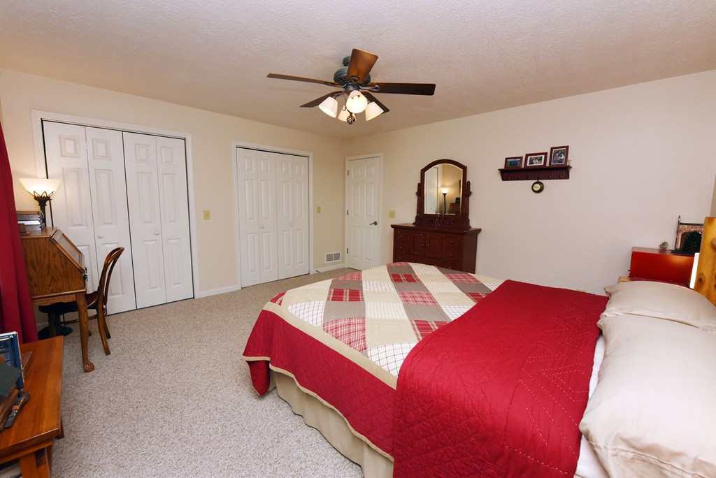 31 Lance Crossing Road Blairsville, GA 30512 - Photo 42 of 52 a bedroom with a bed and a chandelier