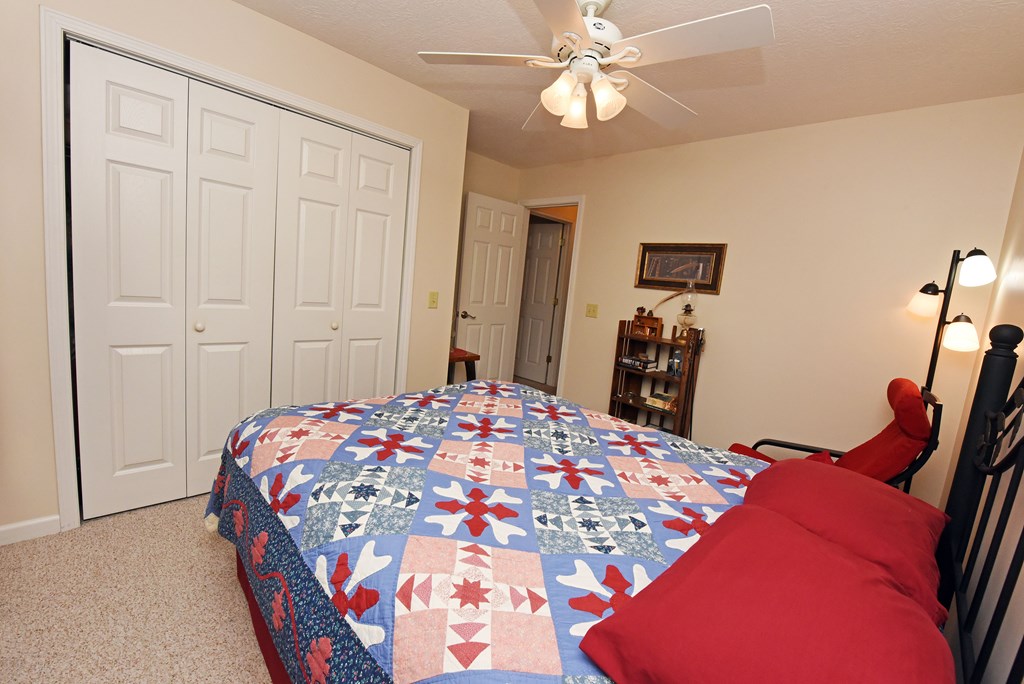 31 Lance Crossing Road Blairsville, GA 30512 - Photo 45 of 52 a bedroom with a bed and a chandelier