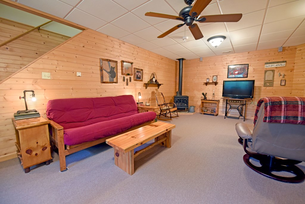 31 Lance Crossing Road Blairsville, GA 30512 - Photo 10 of 52 a living room with furniture a flat screen tv and gym equipment
