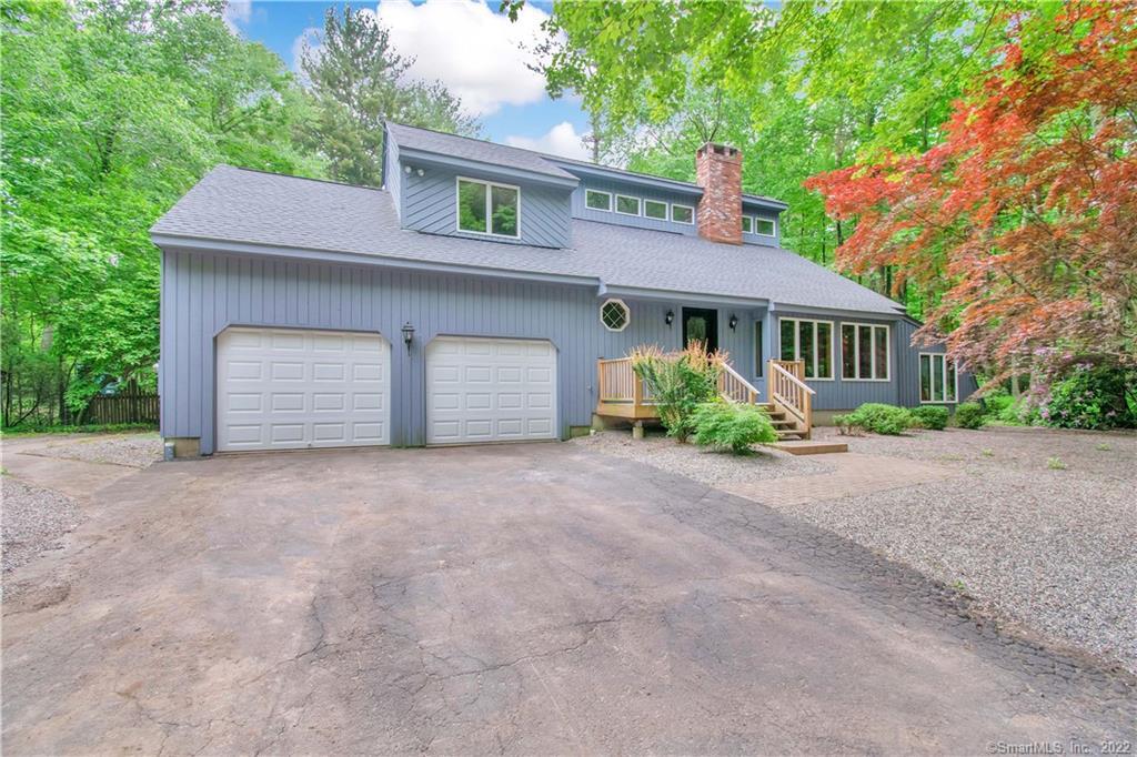 104 Petersen Road Granby, CT 06035 - Photo 1 of 1 a front view of a house with a yard and garage