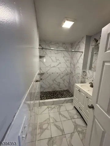 a bathroom with a shower and a sink