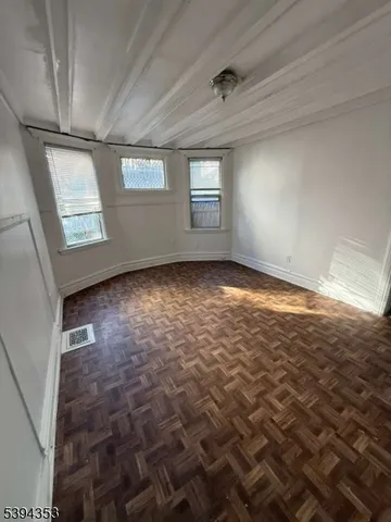 a view of an empty room with windows