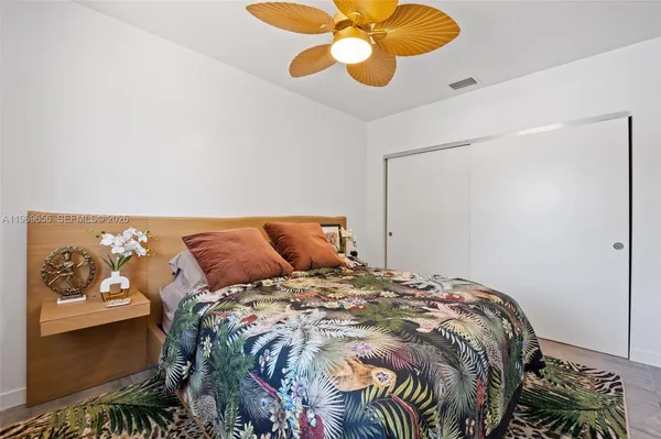 a bed sitting in a bedroom next to a window