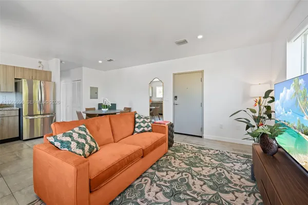 a living room with furniture and a potted plant