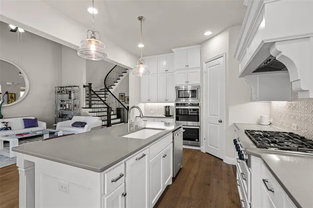 a dining room with furniture a chandelier and wooden floor