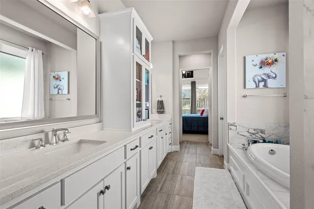 a white bath tub sitting next to a white sink