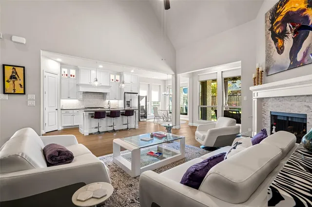 a living room with furniture a fireplace and a large mirror