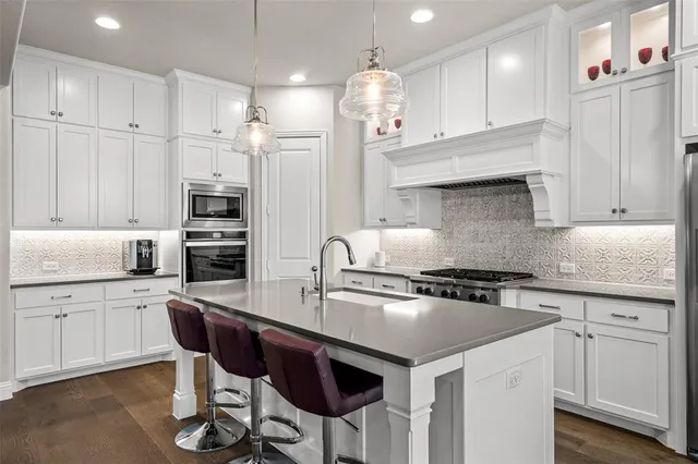 a kitchen with stainless steel appliances a sink and cabinets
