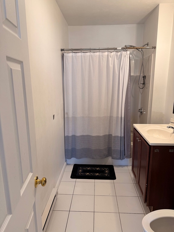 1442 Main Street, Unit 2 Worcester, MA 01603 - Photo 9 of 14 a bathroom with a sink a mirror and a shower