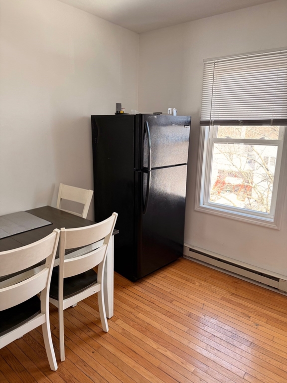 1442 Main Street, Unit 2 Worcester, MA 01603 - Photo 10 of 14 a kitchen with a wooden floor and a refrigerator