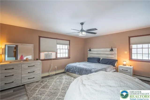 a bedroom with a large bed and a chandelier