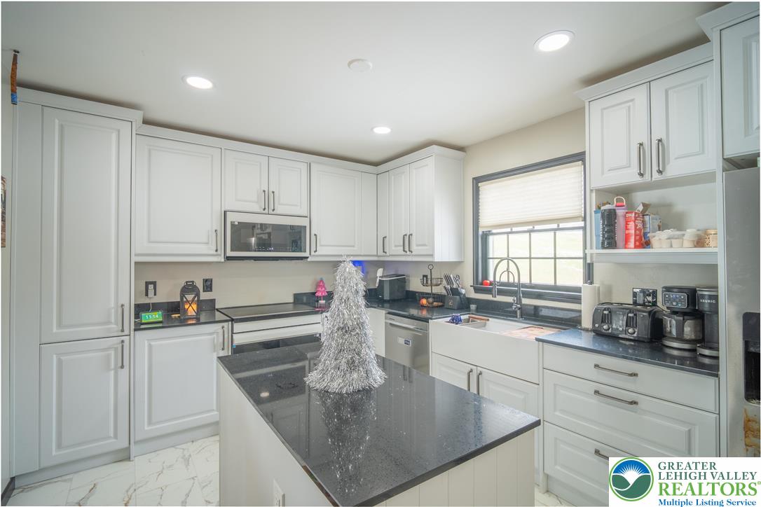 3955 Coplay Creek Road Schnecksville, PA 18078 - Photo 14 of 34 a kitchen with kitchen island granite countertop a sink a stove and cabinets