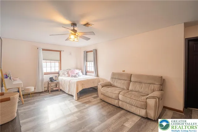 a bathroom with a double vanity sink toilet mirror and shower