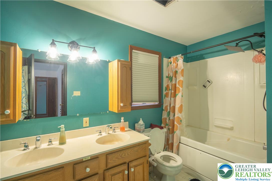 3955 Coplay Creek Road Schnecksville, PA 18078 - Photo 20 of 34 a bathroom with a double vanity sink toilet mirror and shower