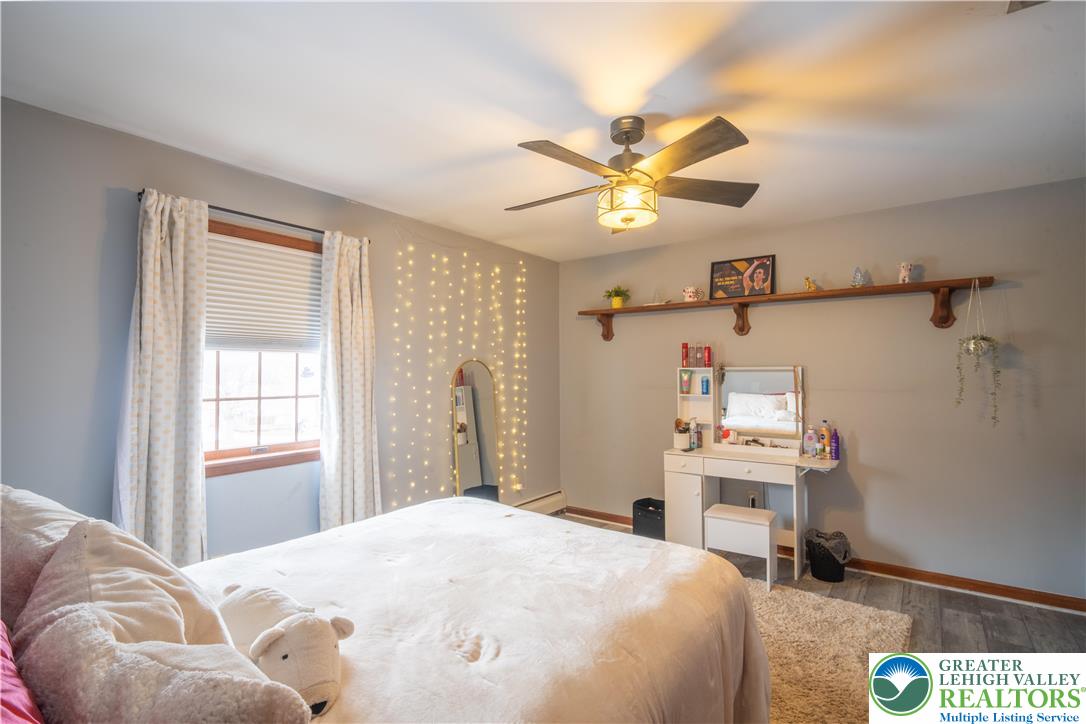 3955 Coplay Creek Road Schnecksville, PA 18078 - Photo 24 of 34 a bedroom with a bed and a chandelier