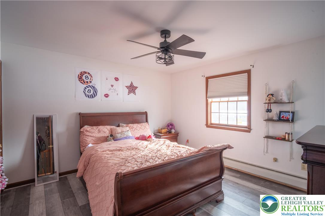 3955 Coplay Creek Road Schnecksville, PA 18078 - Photo 27 of 34 a bedroom with a bed and a chandelier