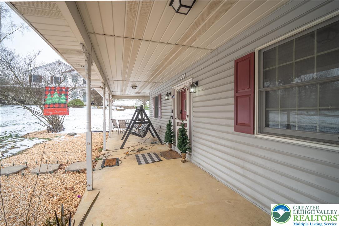 3955 Coplay Creek Road Schnecksville, PA 18078 - Photo 5 of 34 a view of a porch with furniture and floor to ceiling window