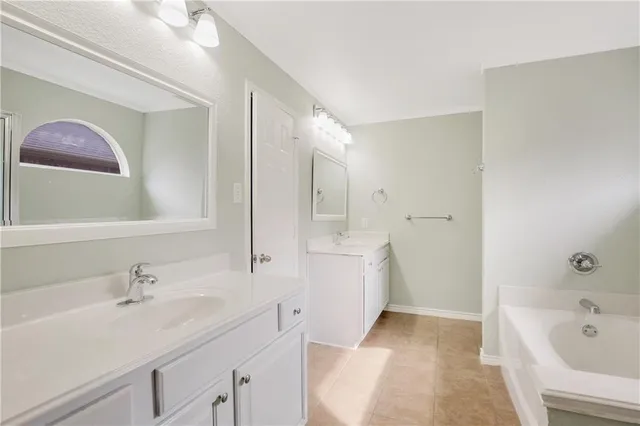 a white bath tub sitting next to a shower