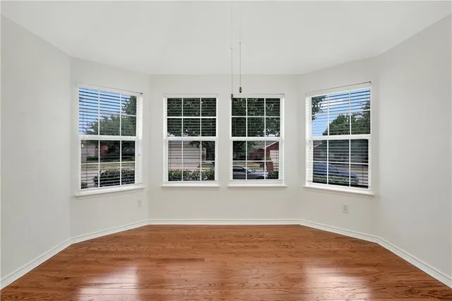 a view of an empty room and wooden floor