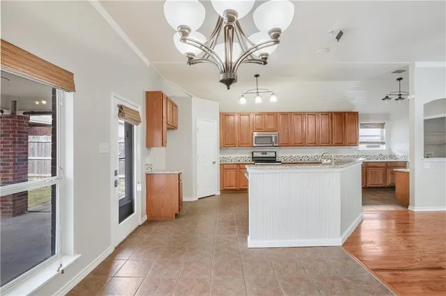 a view of a kitchen with a sink cabinets and a fireplace