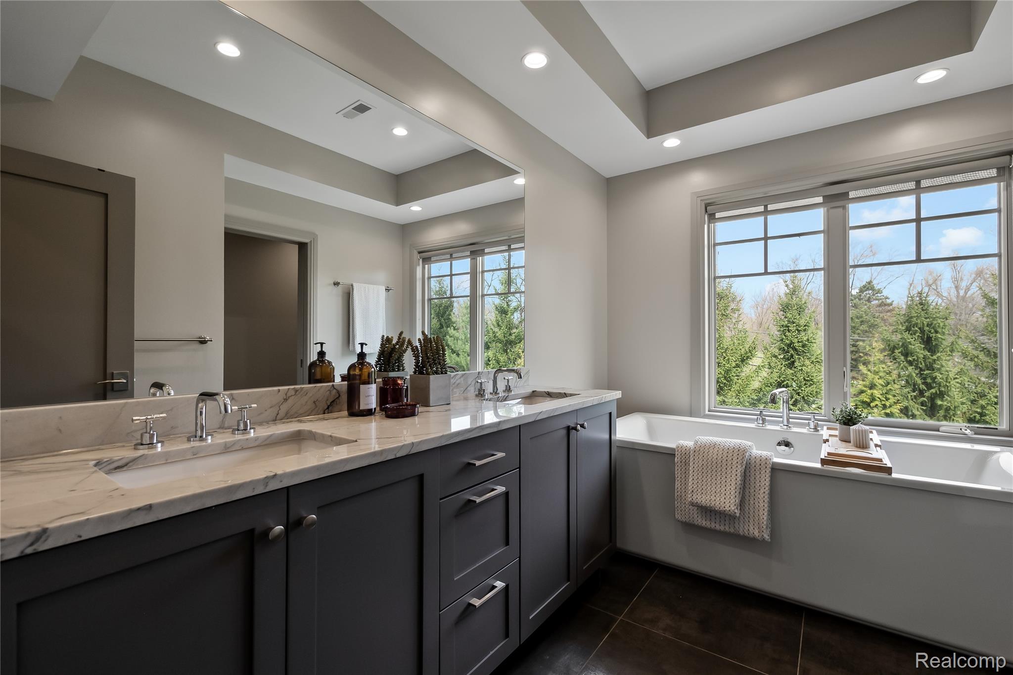 3824 Poppleton Street Troy, MI 48084 - Photo 24 of 51 Full bath featuring double vanity, a raised ceiling, a freestanding tub, recessed lighting, and dark tile patterned floors