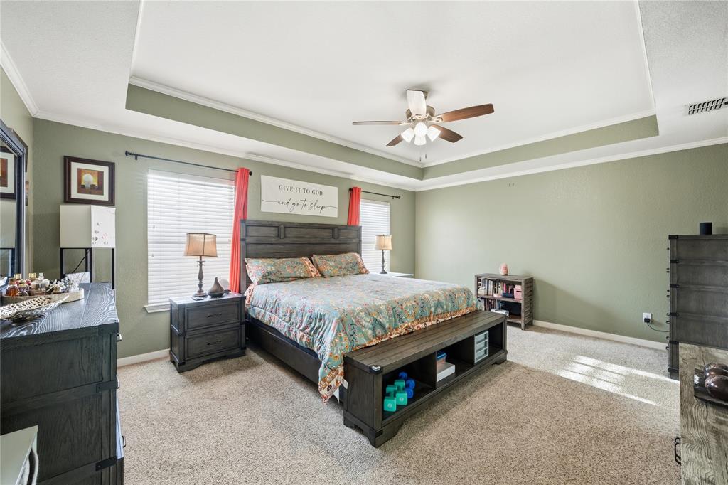 10504 Whitney Trace Drive Waco, TX 76708 - Photo 10 of 24 a spacious bedroom with a bed and a chandelier