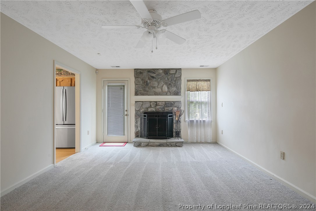 51 Overlook Road Cameron, NC 28326 - Photo 11 of 40 an empty room with fireplace and windows