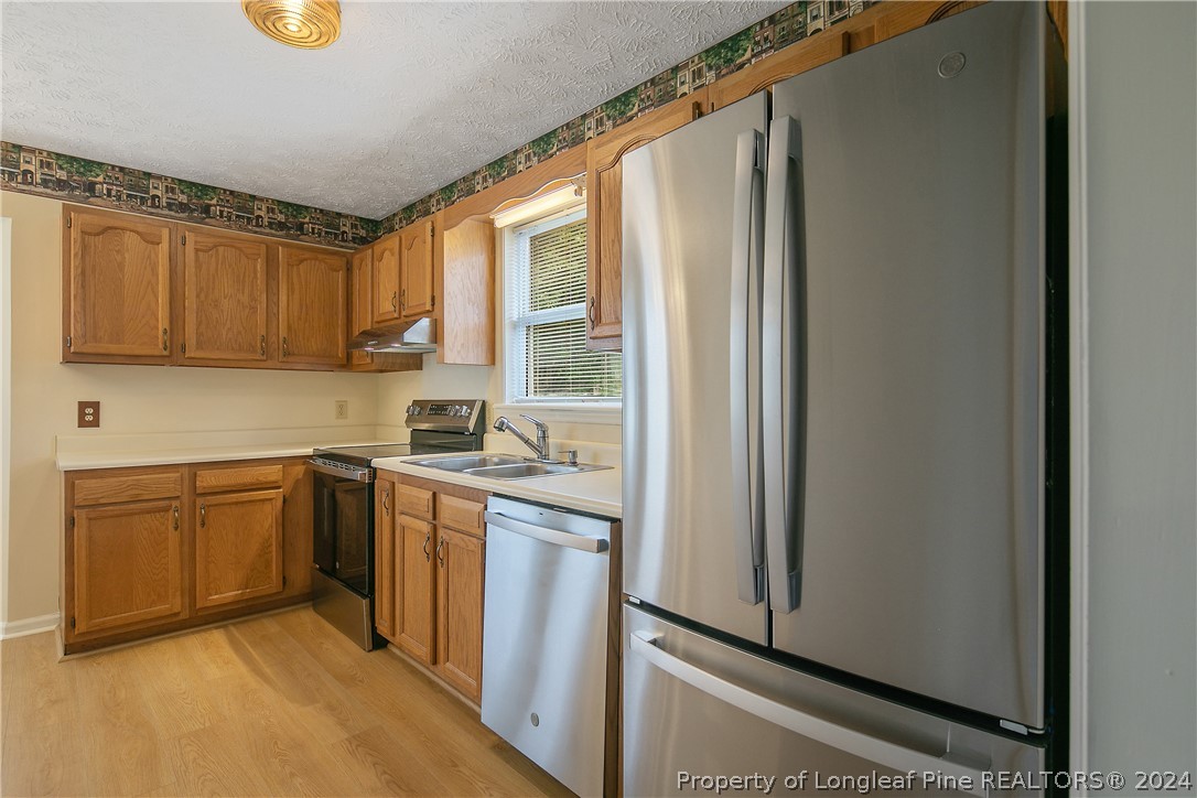 51 Overlook Road Cameron, NC 28326 - Photo 12 of 40 a kitchen with stainless steel appliances granite countertop a refrigerator and a sink