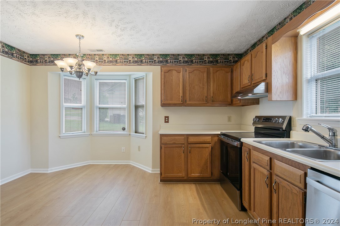 51 Overlook Road Cameron, NC 28326 - Photo 13 of 40 a kitchen with cabinets wooden floor appliances and a window