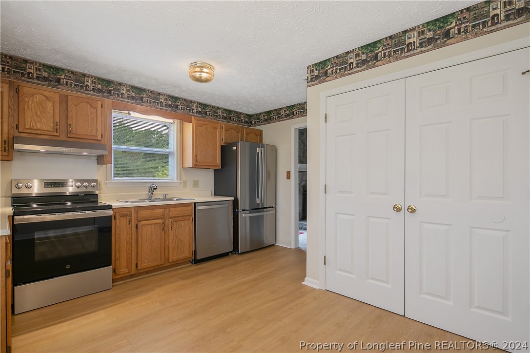 51 Overlook Road Cameron, NC 28326 - Photo 17 of 40 a kitchen with a refrigerator and a stove top oven