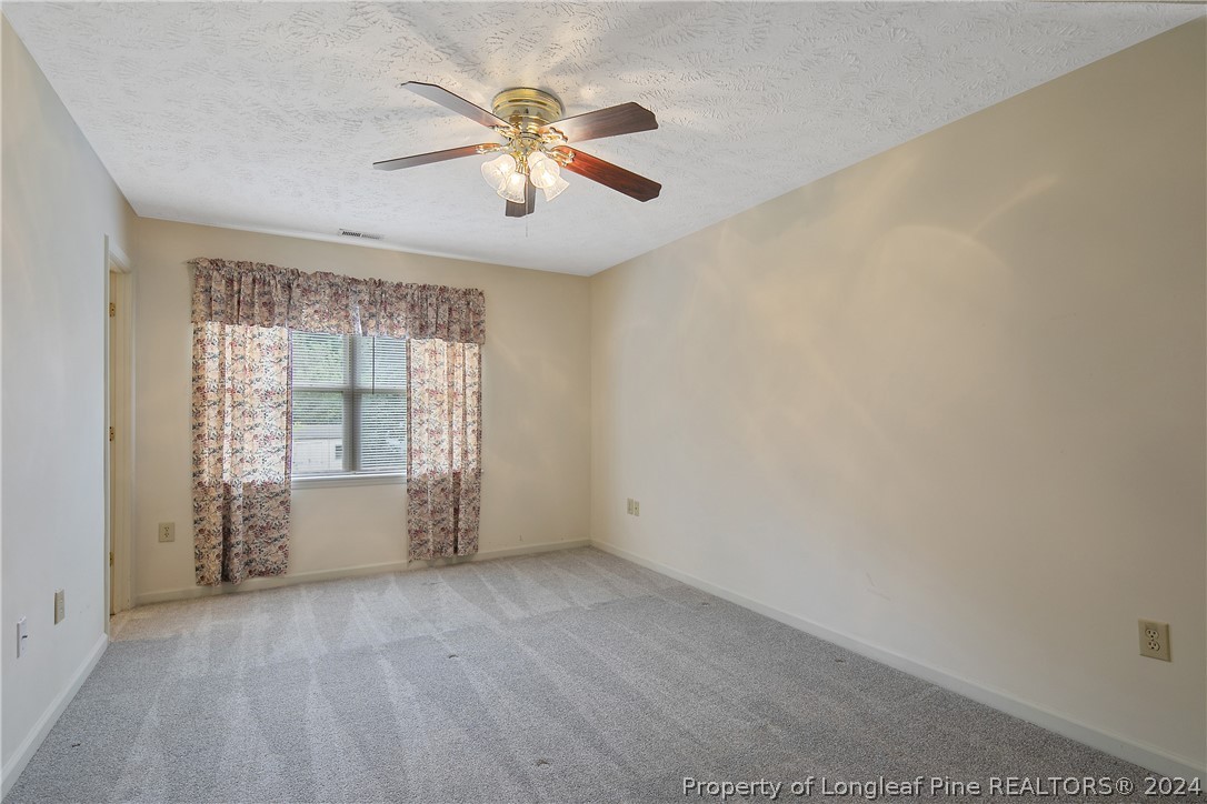 51 Overlook Road Cameron, NC 28326 - Photo 20 of 40 an empty room with windows and chandelier fan