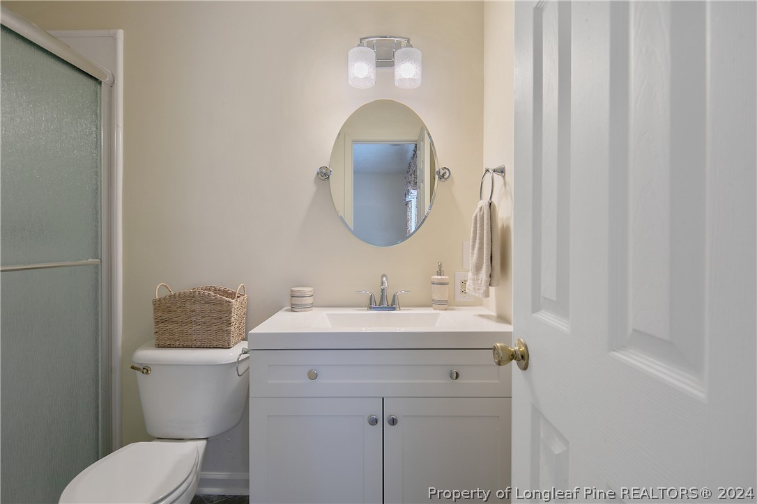 51 Overlook Road Cameron, NC 28326 - Photo 24 of 40 a bathroom with a toilet sink and mirror