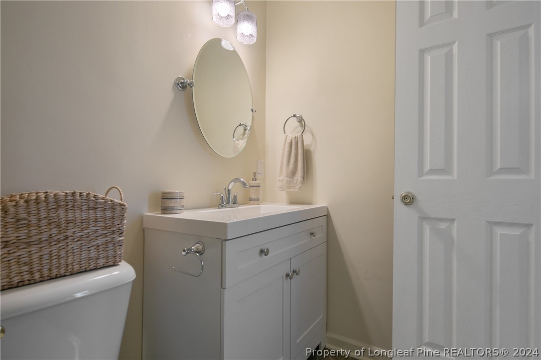 51 Overlook Road Cameron, NC 28326 - Photo 25 of 40 a bathroom with a sink a toilet and a mirror
