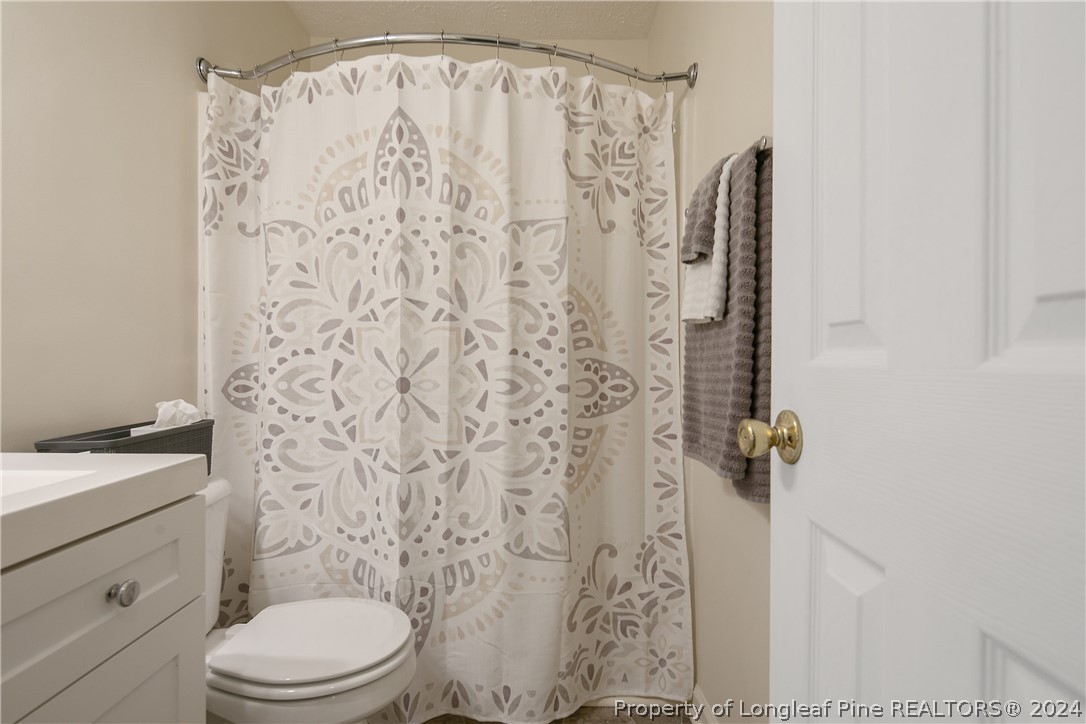 51 Overlook Road Cameron, NC 28326 - Photo 31 of 40 a bathroom with a shower curtain
