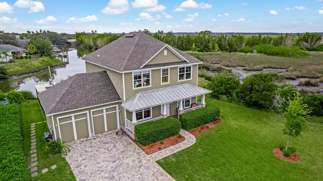 a aerial view of a house next to a yard
