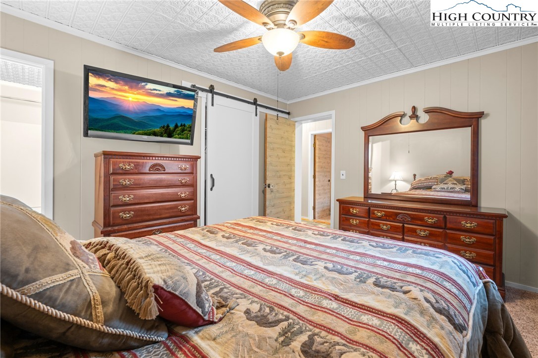 301 Pinnacle Inn Road, Unit 3219 Beech Mountain, NC 28604 - Photo 14 of 30 a bedroom with a bed and a flat screen tv