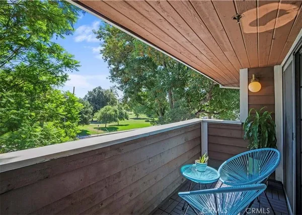 a view of a porch with furniture and a yard