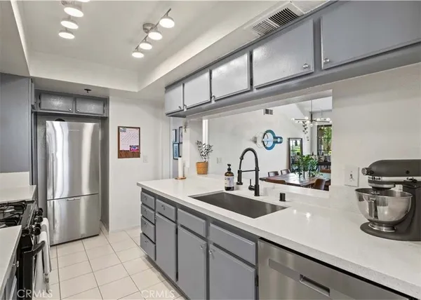 a kitchen with sink refrigerator and stove