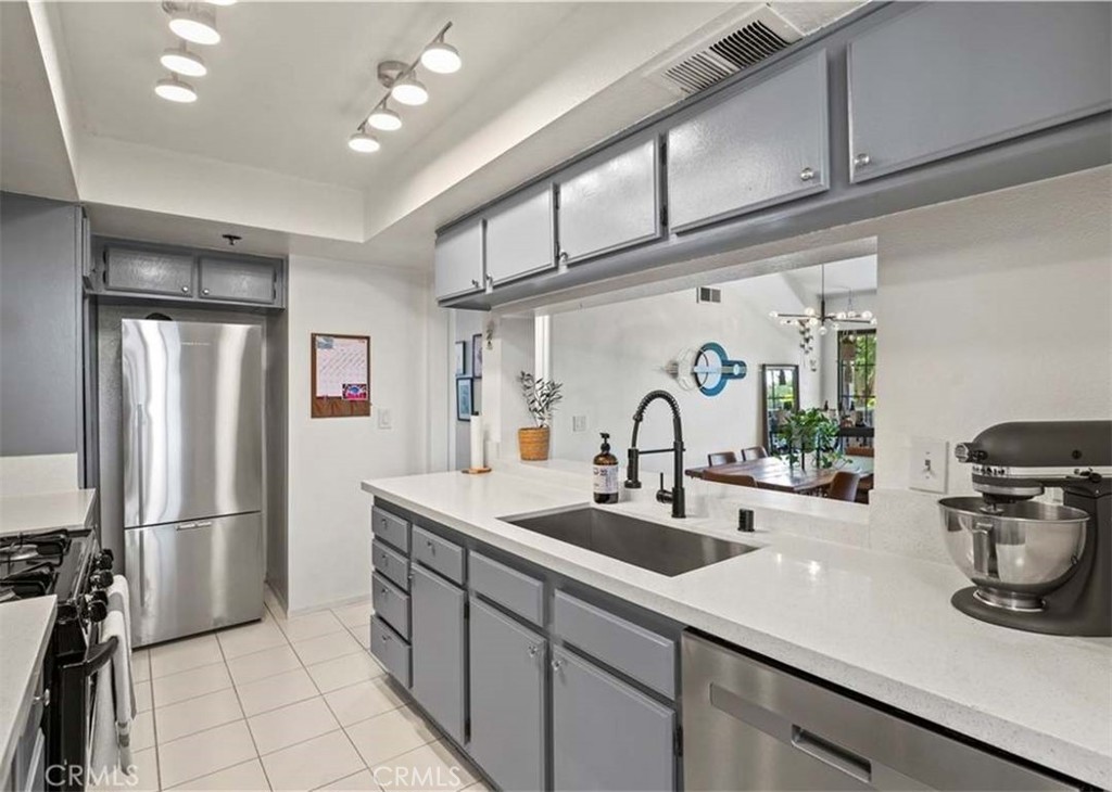6545 Reseda Boulevard, Unit 17 Reseda, CA 91335 - Photo 5 of 13 a kitchen with sink refrigerator and stove