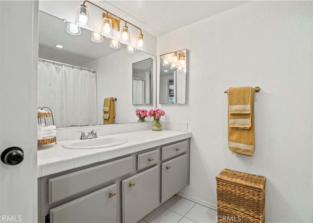 6545 Reseda Boulevard, Unit 17 Reseda, CA 91335 - Photo 10 of 13 a bathroom with a sink and a mirror