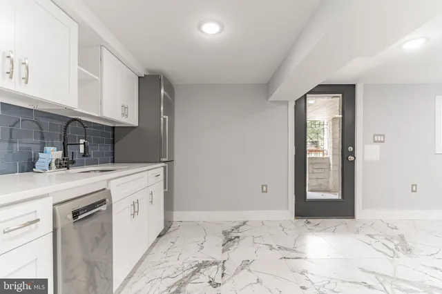 a kitchen with a stove top oven and cabinets