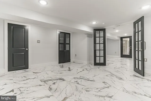 a large white kitchen with kitchen island a sink a stove a refrigerator and cabinets