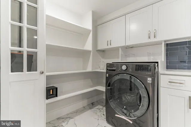 a kitchen with stainless steel appliances granite countertop a sink refrigerator and cabinets