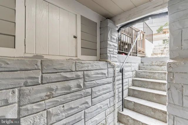 a view of a patio with couches table and chairs and potted plants