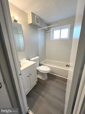 a bathroom with a toilet sink and a mirror