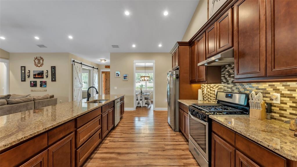 3430 North Galloway Road Lakeland, FL 33810 - Photo 15 of 84 a large kitchen with stainless steel appliances granite countertop a lot of counter space and wooden floor